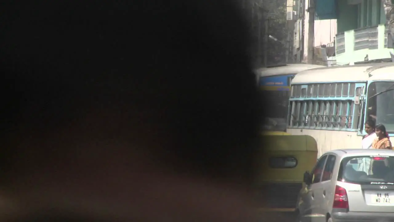 Vehicles and pedestrians navigate an intersection with heavy traffic