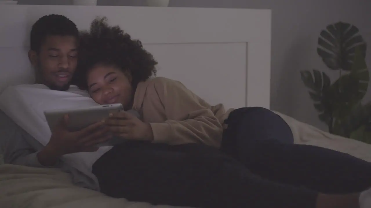 Young Couple Watching A Movie On The Tablet