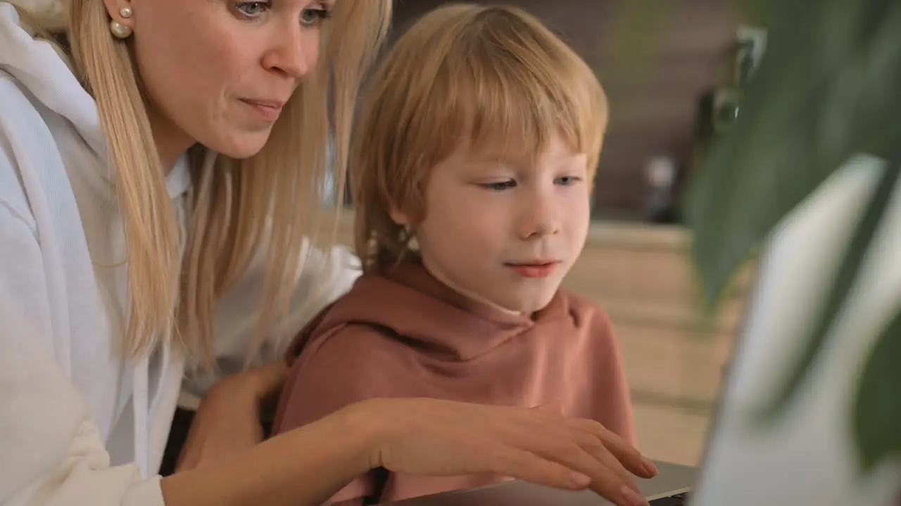 Little Boy And Mother Using Laptop And Having Fun At Home