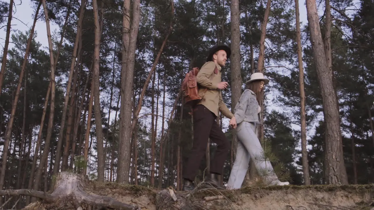 Couple Taking A Walk In The Forest At Sunset