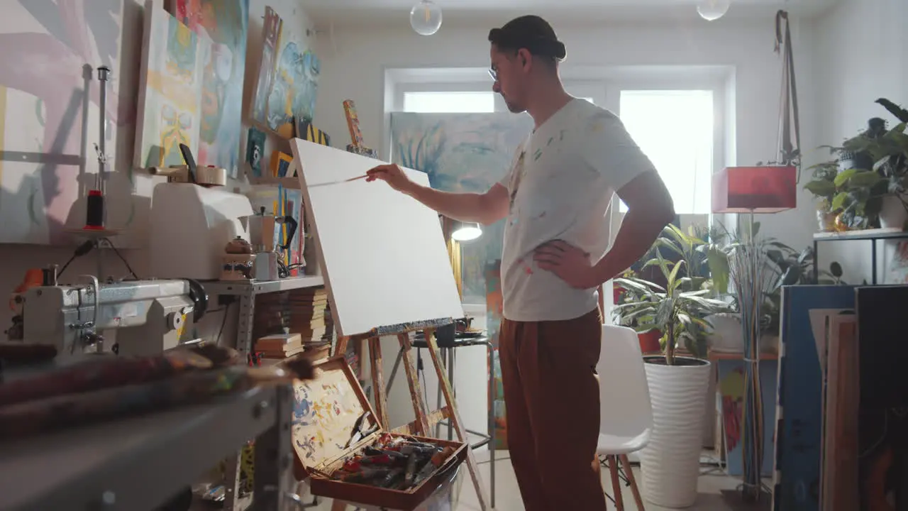 Artist Drawing Picture on Canvas in Art Studio