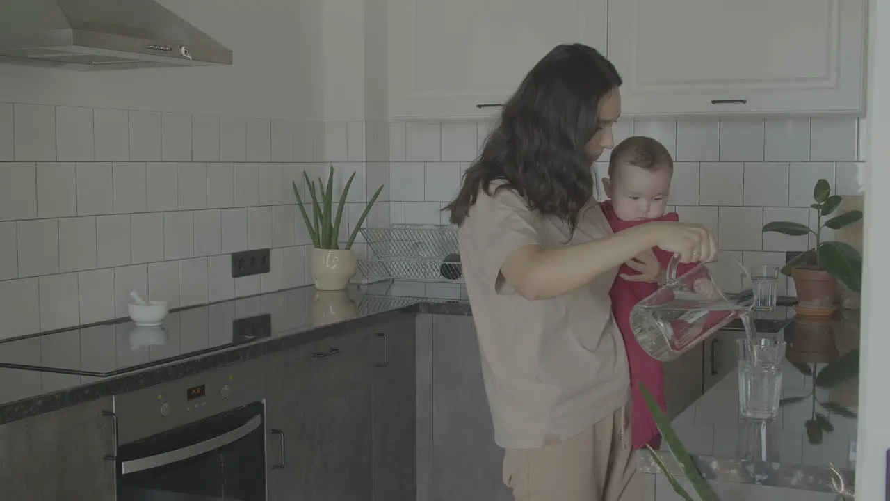 Mom And Cute Baby In Kitchen Copy Space