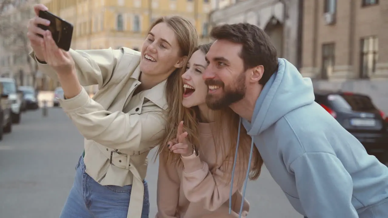 A Group Of Three Young Friends Taking A Funny Selfie