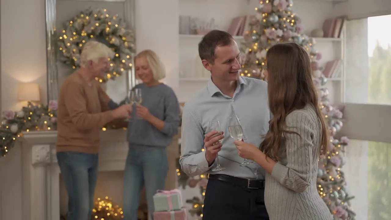 Two Generations Of Couples Celebrating Christmas At Home