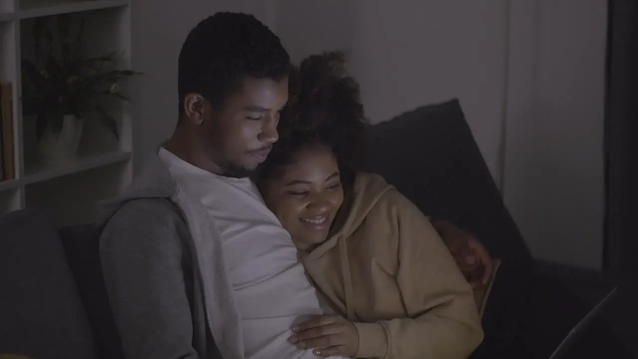 Young Couple Laughing While Watching A Film On The Laptop