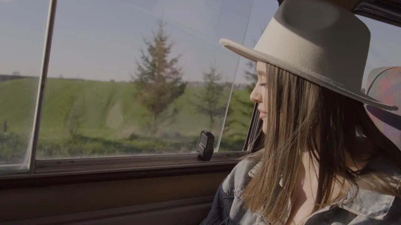 A Young Woman Looks Out The Window Of The Caravan On A Roadtrip