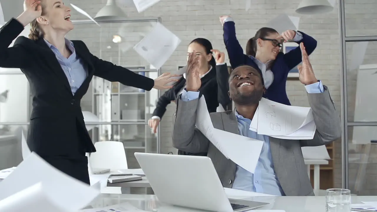 Worker Women And Man Dressed In Suits At The Office They Dance And Celebrate While Throwing Documents