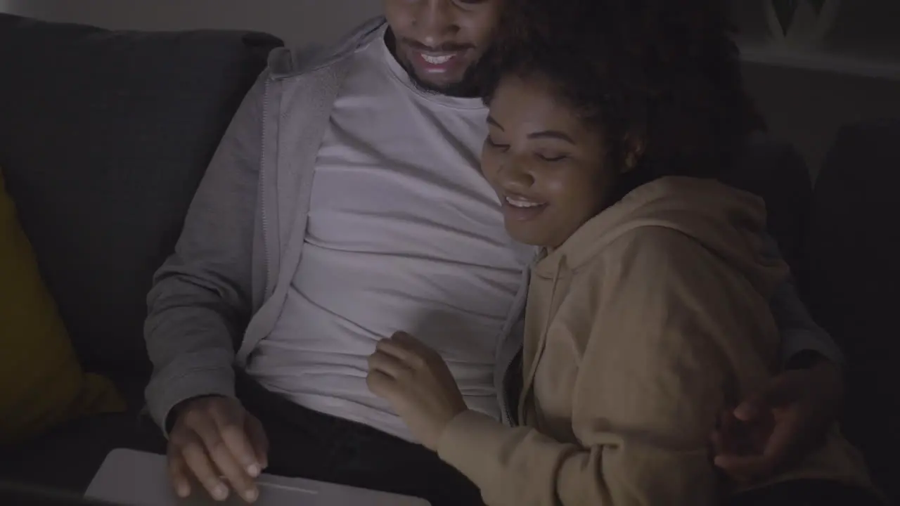 Young Couple Choosing A Film To Watch On The Laptop