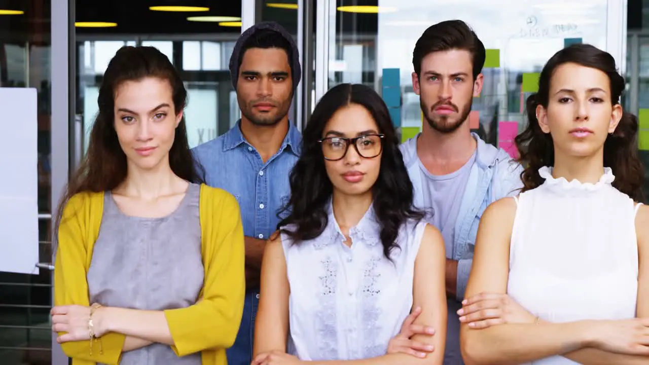 Portrait of executives standing with arms crossed