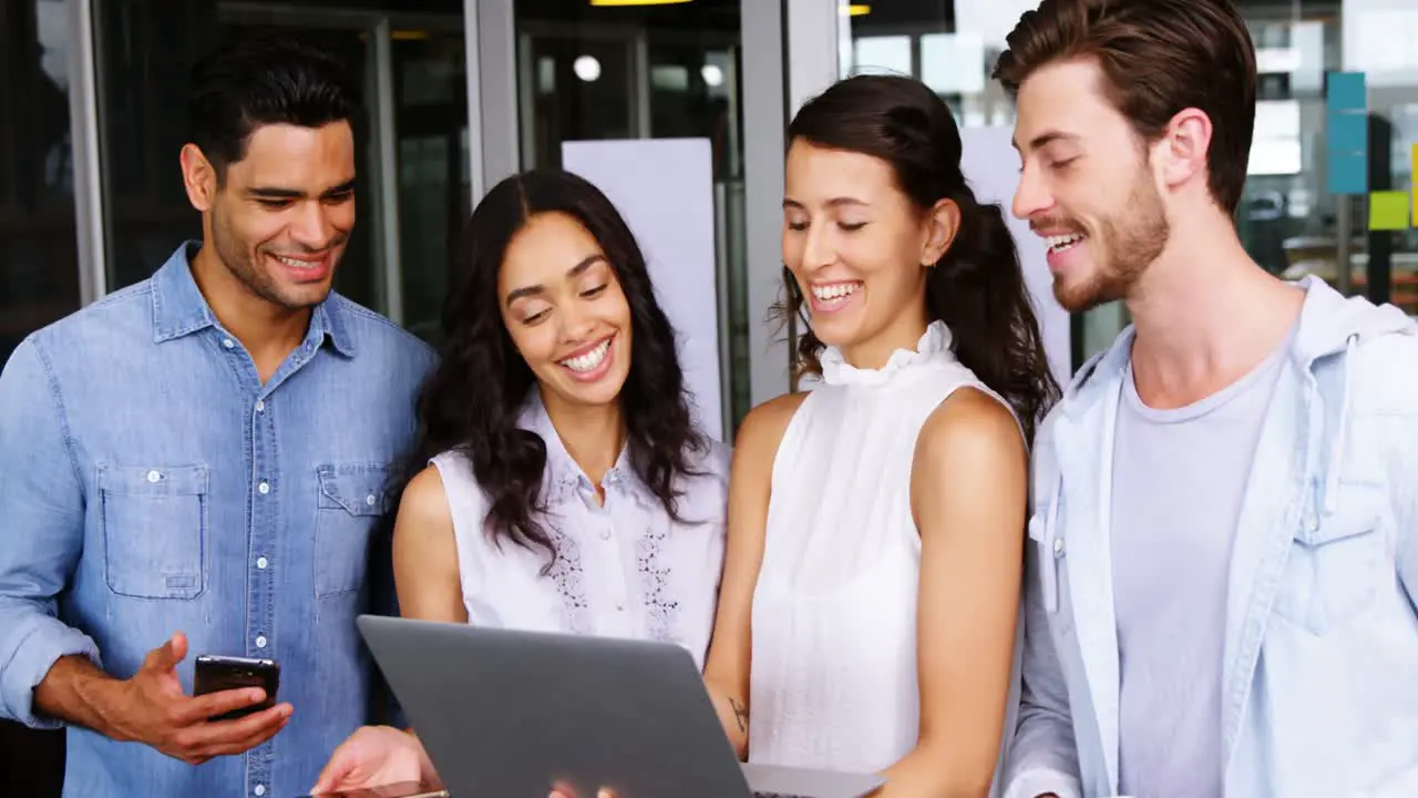 Happy executives using laptop