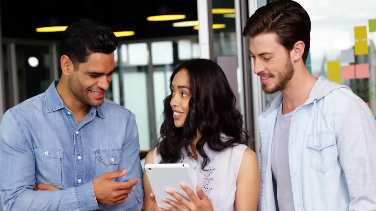 Happy executives using digital tablet