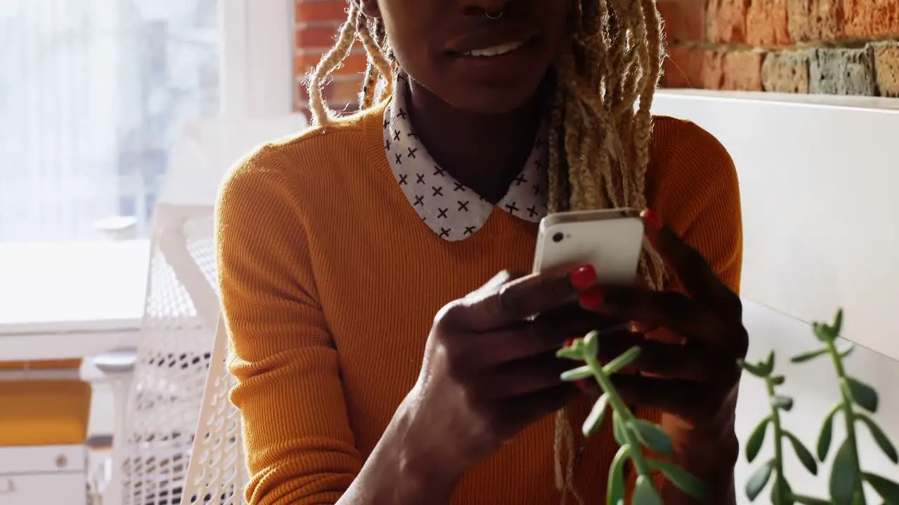 Female executive using mobile phone