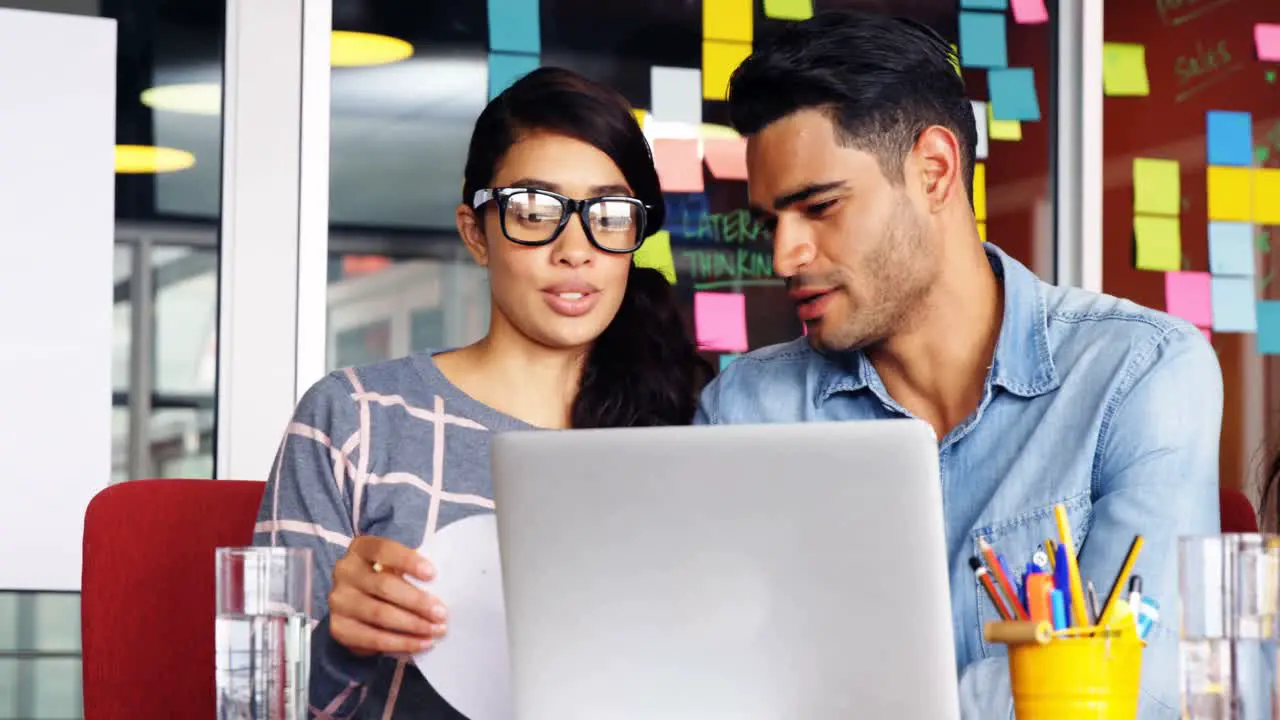 Executives interacting with each other while working