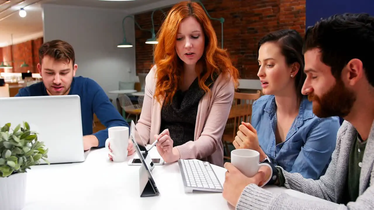 Business executives discussing over digital tablet