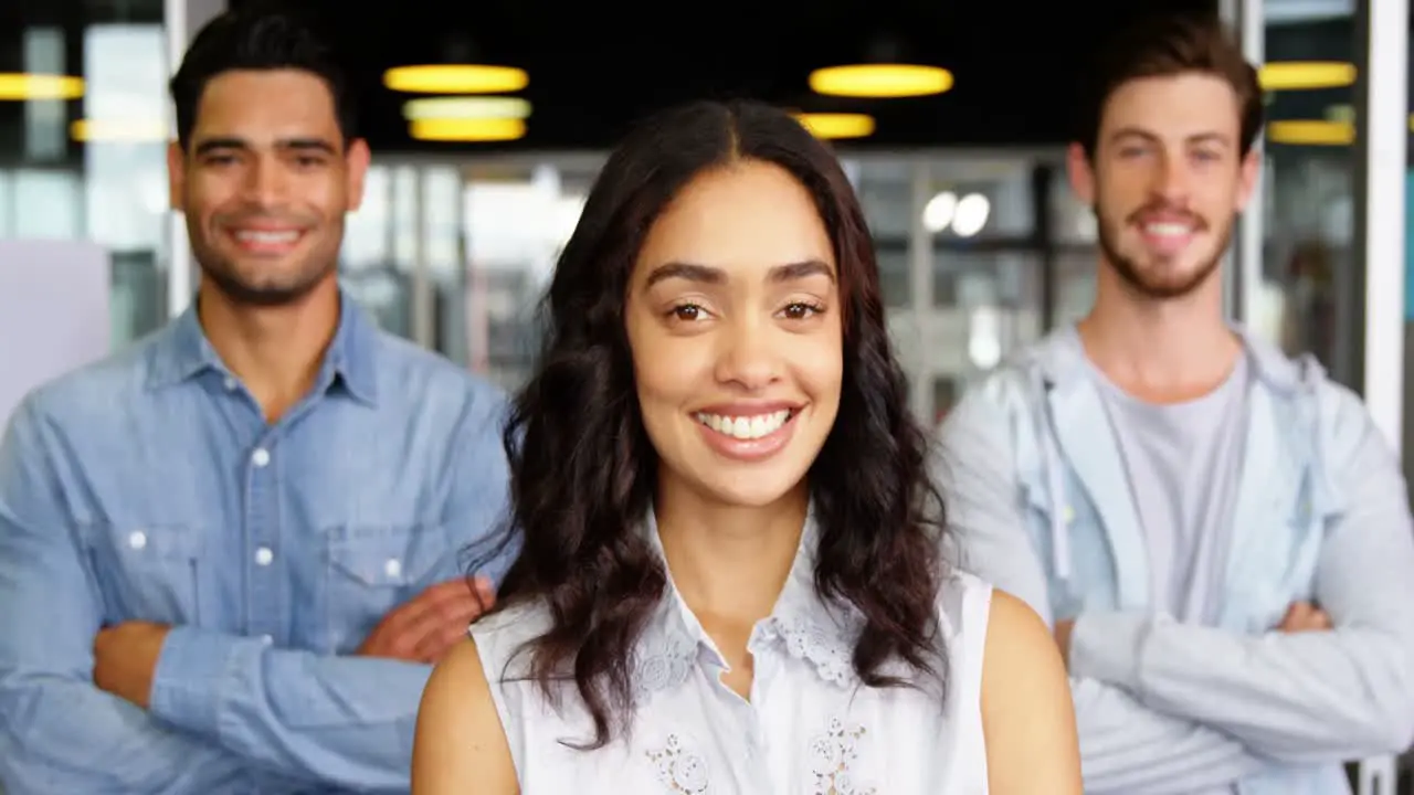 Portrait of happy executives standing with arms crossed