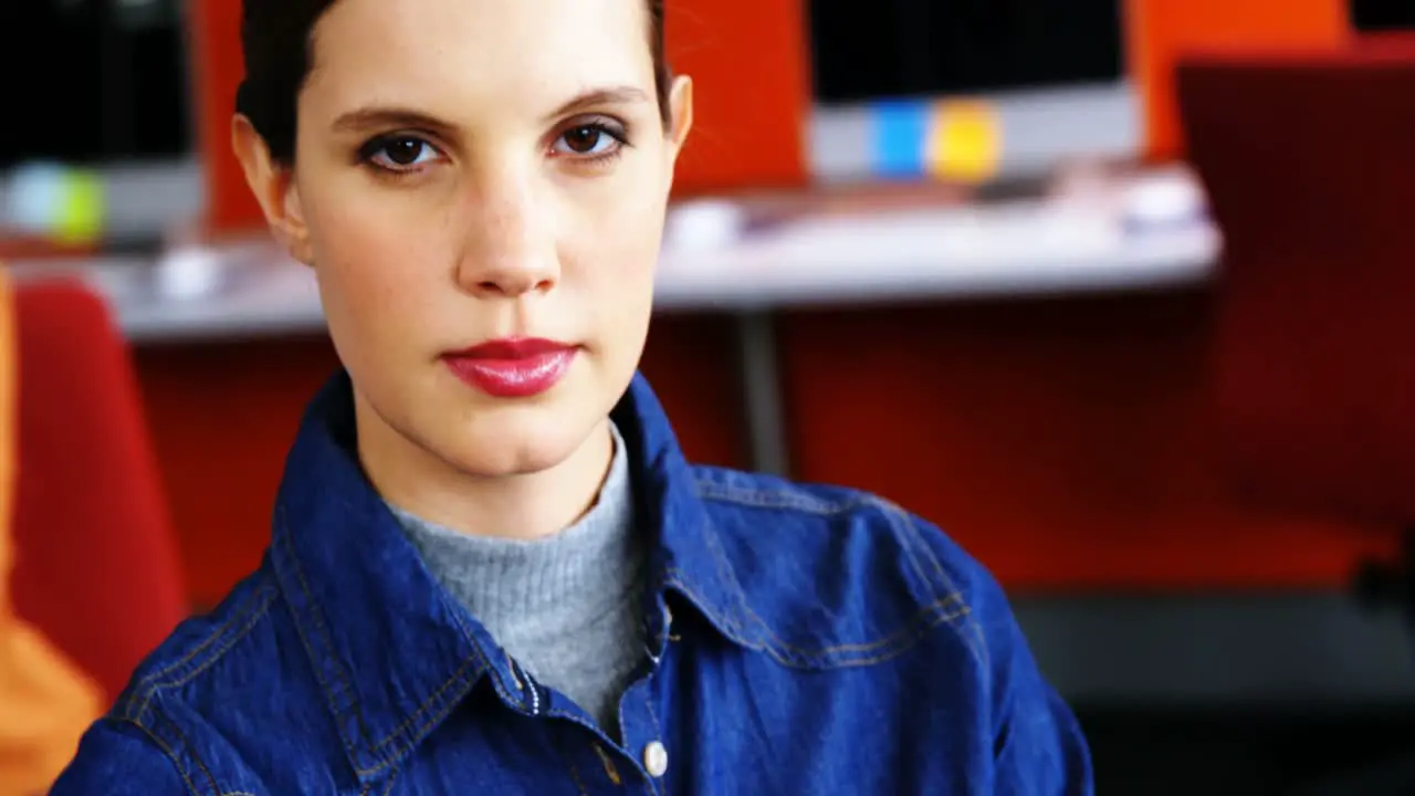 Portrait of female executive standing with arms crossed