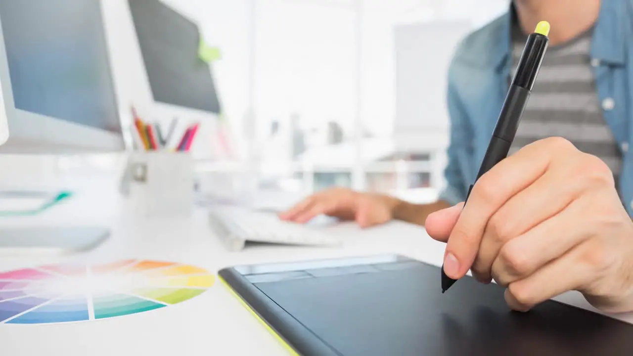 Video of creative man using graphic digital tablet in modern office