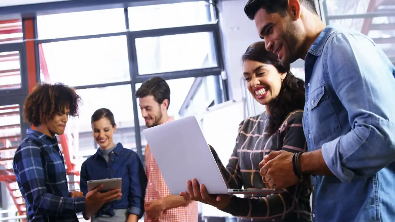 Executives using digital tablet and laptop