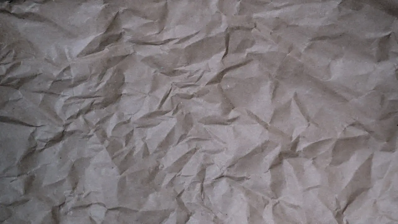 Stop Motion Fast chaotic crumpled brown paper texture for documentary background