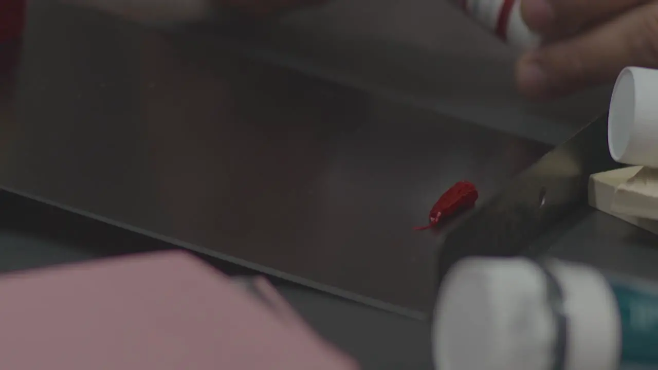 A Man Pouring Textile Ink for Linen Stamp Varnishing Process by Hands