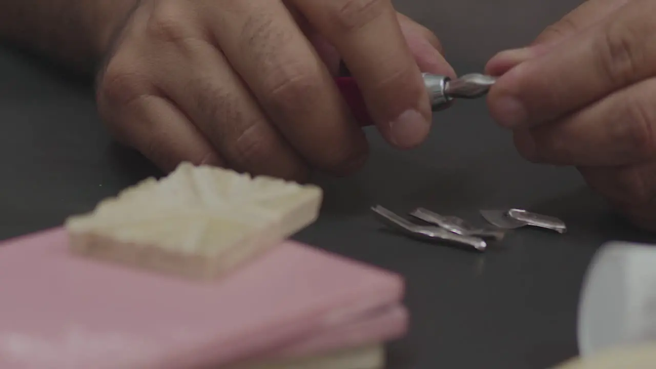 Hands Changing Chisels on the Gouge Close-Up