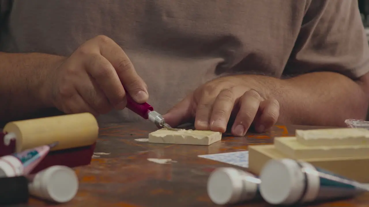 Skilled Hands Carve a Linen Stamp with Precision Medium Close-Up