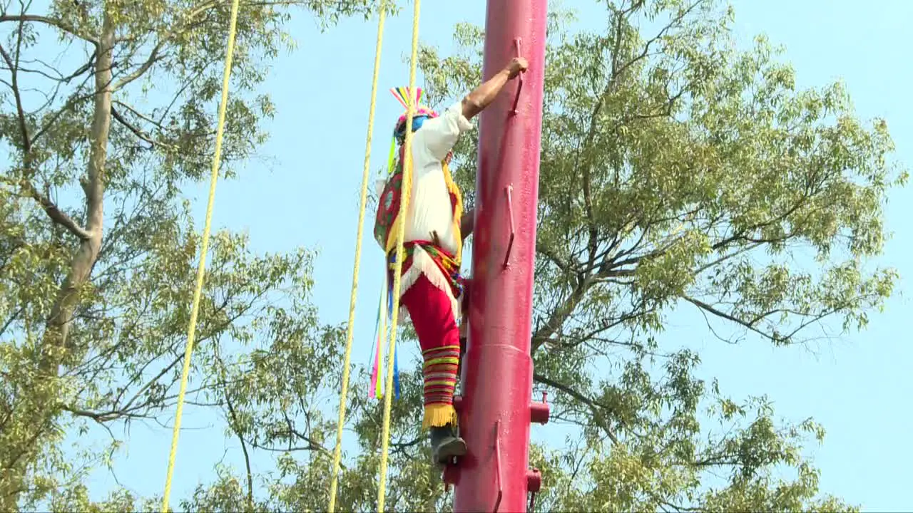 Papanta flyer climbing to the top of the pole before performing the traditional dance