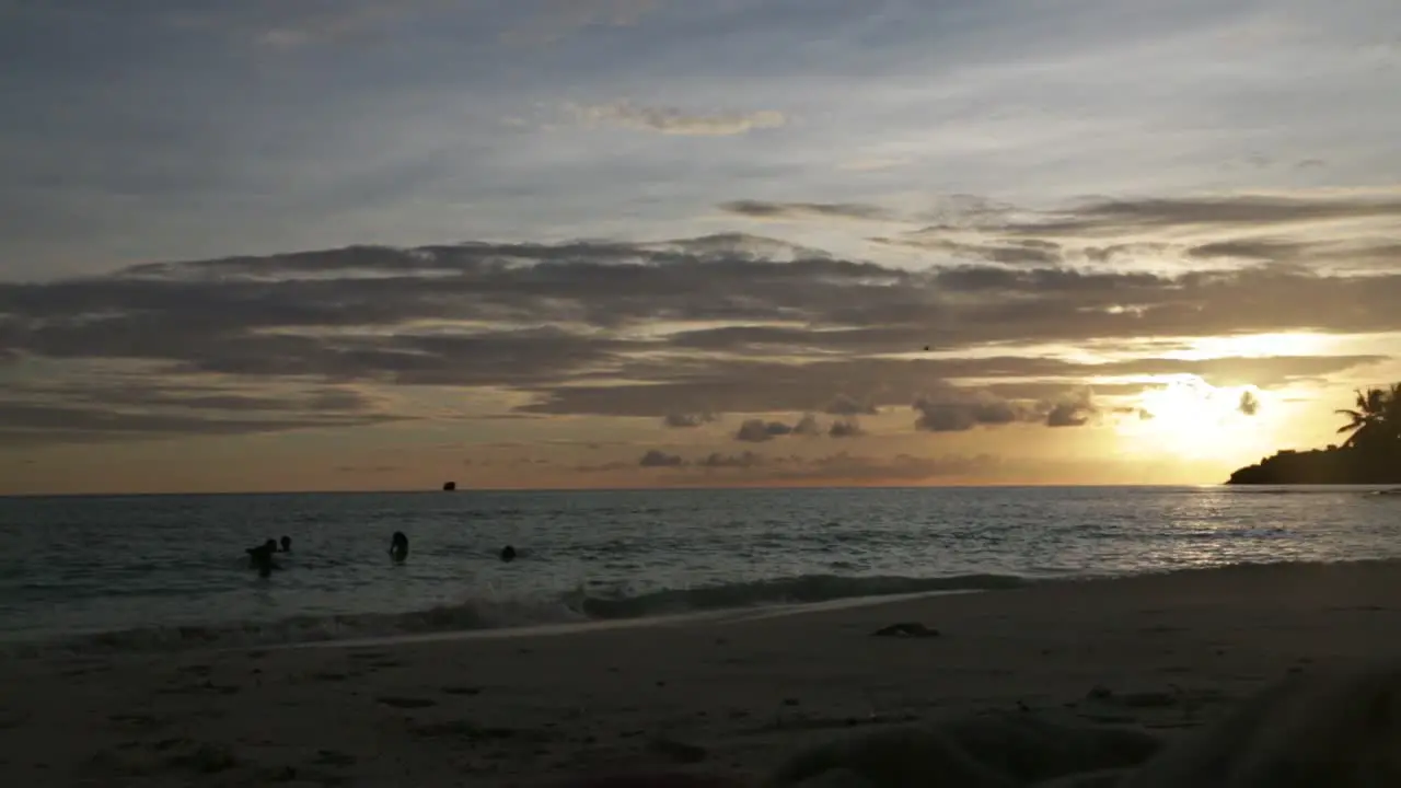 People Taking a Bath at Sunset