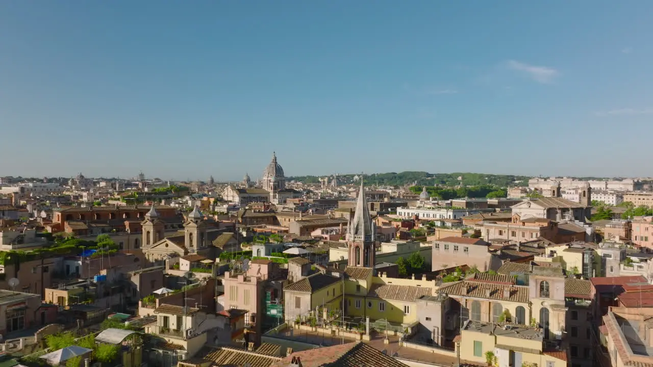 Forwards fly above old buildings and landmarks in historic city centre on sunny morning Rome Italy