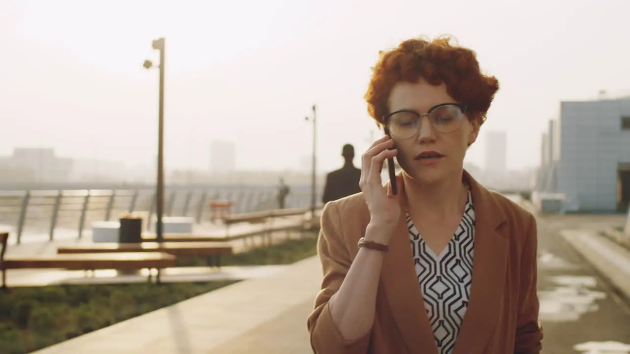 Businesswoman Walking on Street and Having Phone Talk