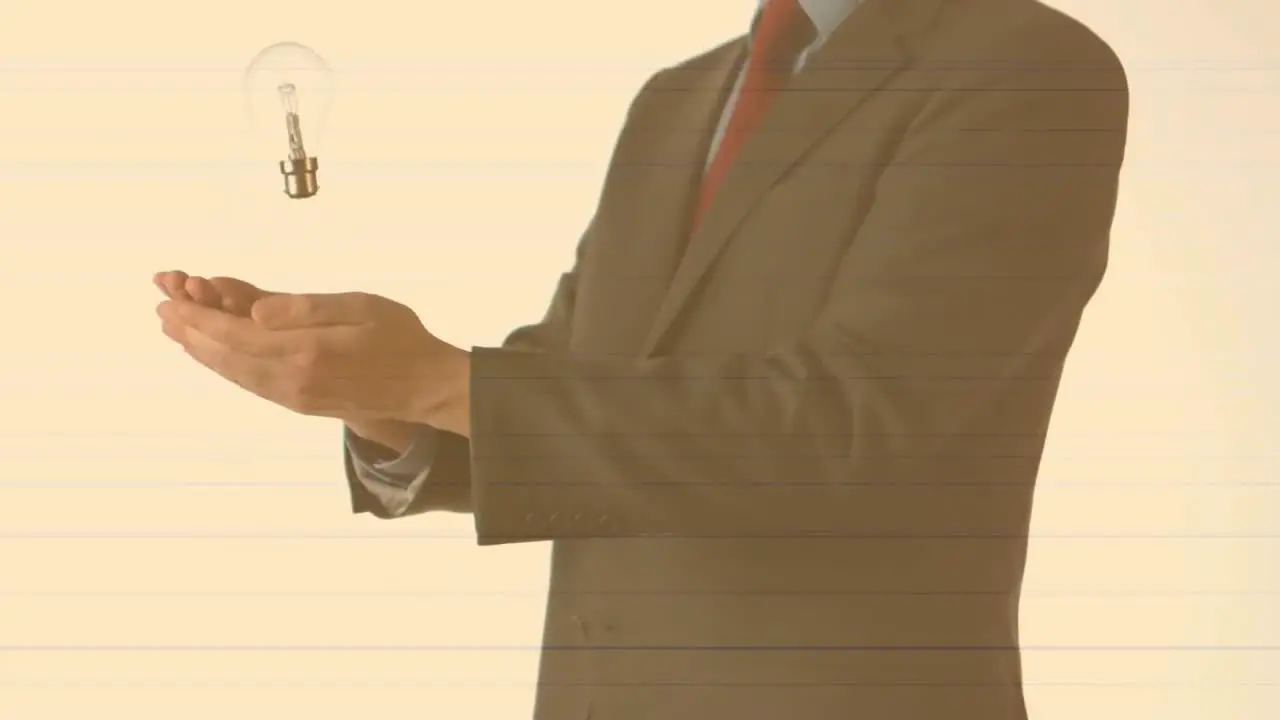 Animation of businessman throwing and catching lightbulb on pale orange background