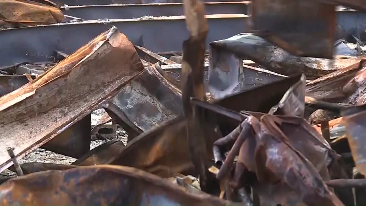 CLEANING UP A BURNT BUILDING USING AN EXCAVATOR