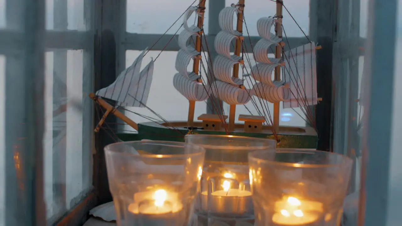 Outdoor lantern with ship model and candles