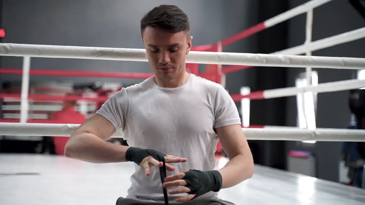 Strong Athlete Man Wrap His Hands With Boxing Bandages Before Training