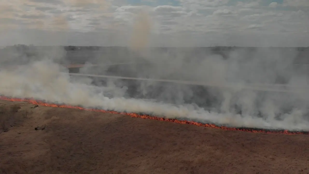 Grassland field on fire with smoke