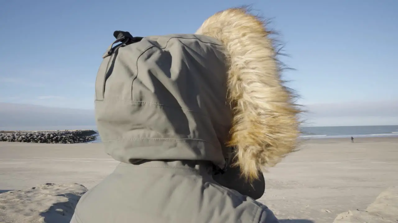 Back view of person with burnout enjoying the fresh sea air