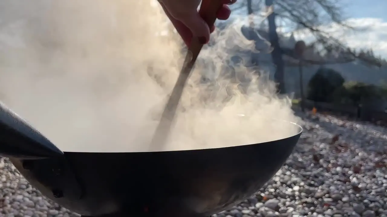 Cooking in a wok over an open fire