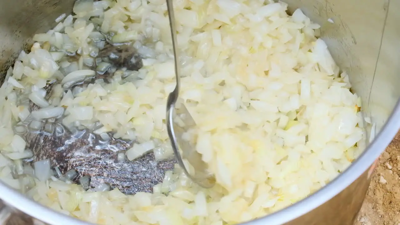 Kosher military food pot with onions frying in the oil