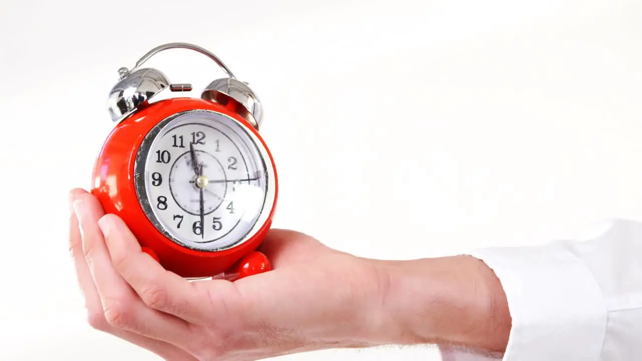 Man hand holding alarm clock