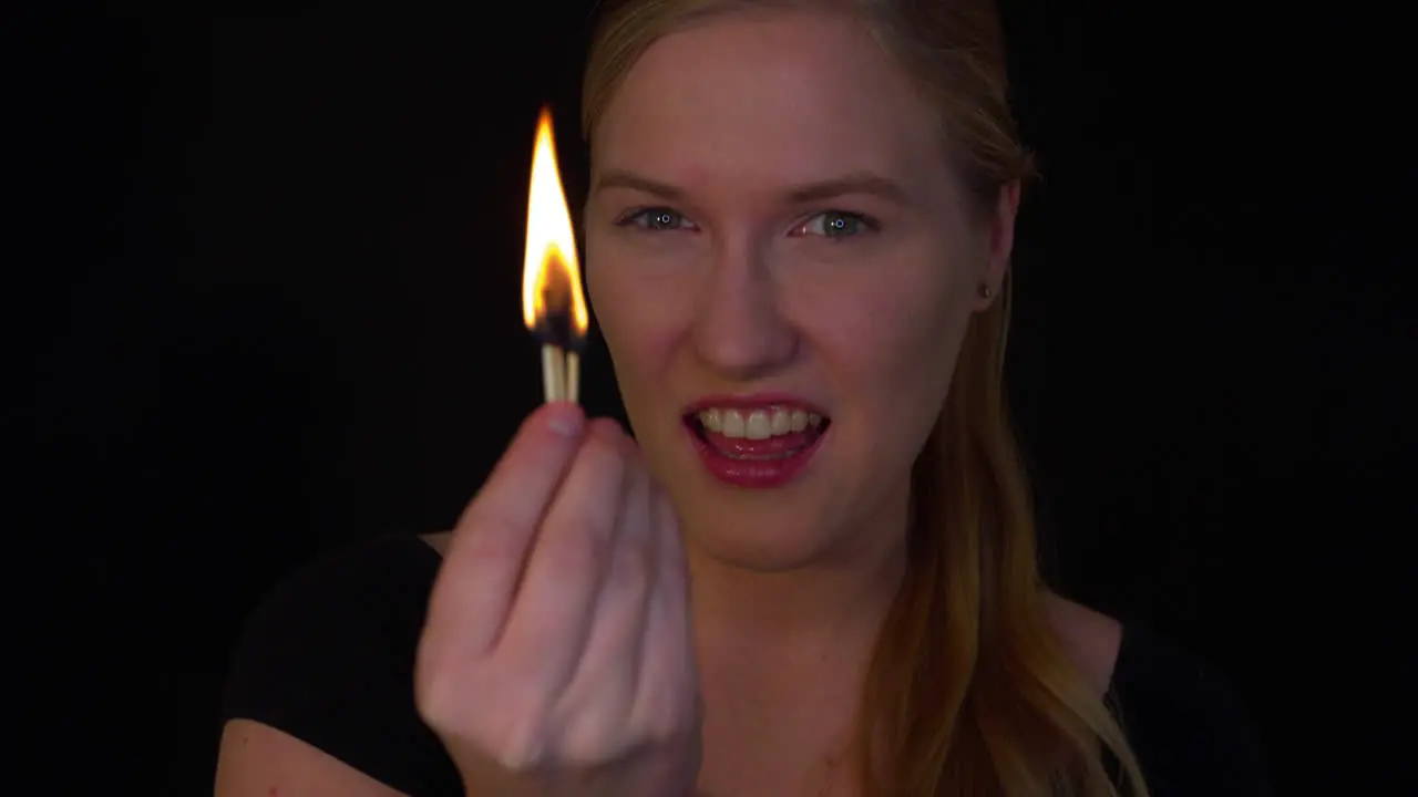 Young woman is playing with a fire