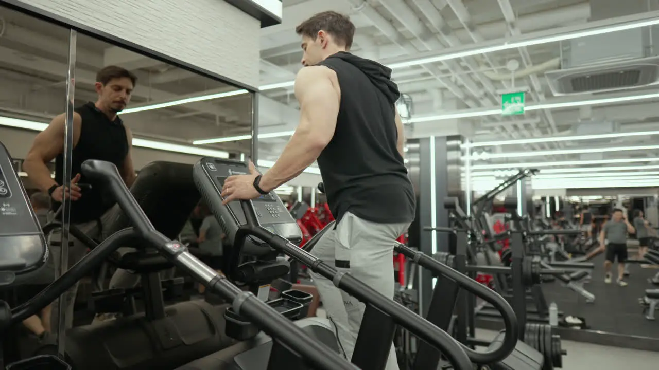 Sporty Man in 30th Exercise on Stepmill Stair Climber Machine in Modern Fintess Center