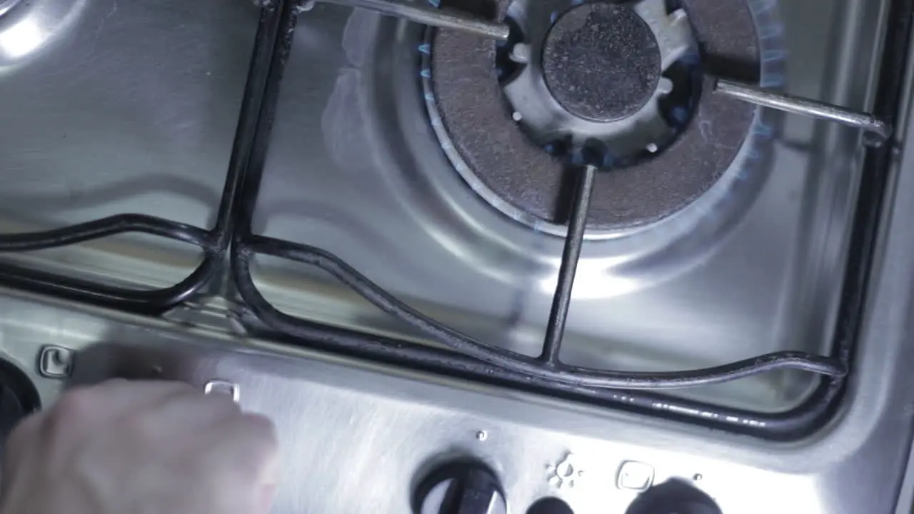 Top view of a man´s hand lighting up a stove burner