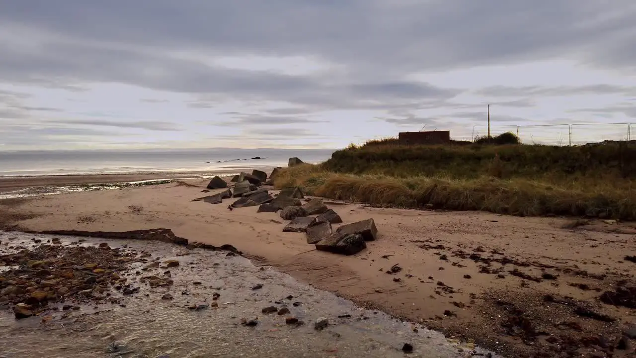 Tiel burn flowing into the Firth of Forth through Kirkcaldy beach with antitank concrete blocks from WW2 on the far bank