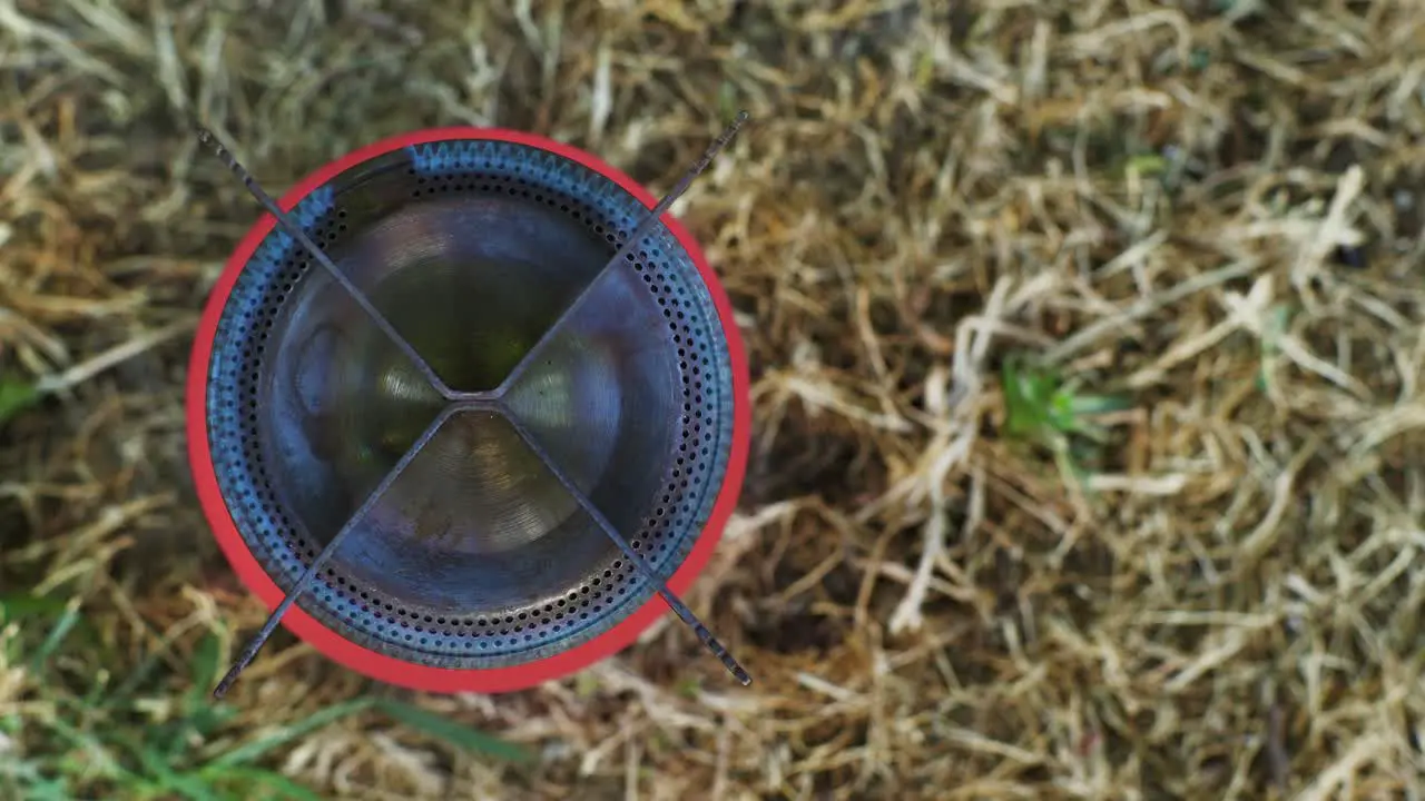 Top view of lighting a camping stove with a match