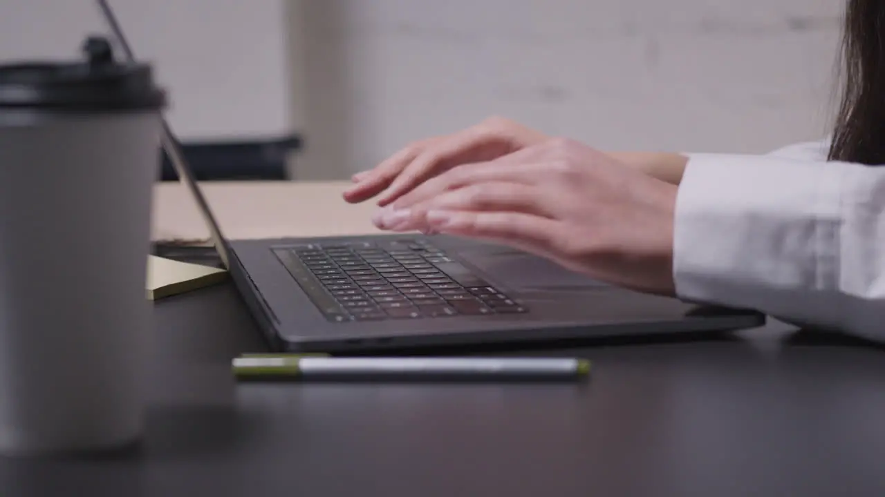 Close Up Of An Unrecognizable Woman Typing On Laptop Computer During A Business Meeting