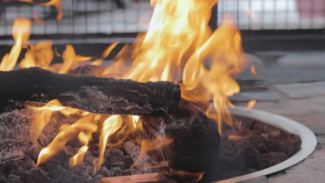 A contained fire burns in the commons area of a small town in Northern Michigan