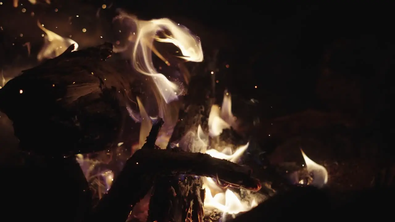 Slow Motion Shot Campfire poked by wooden stick