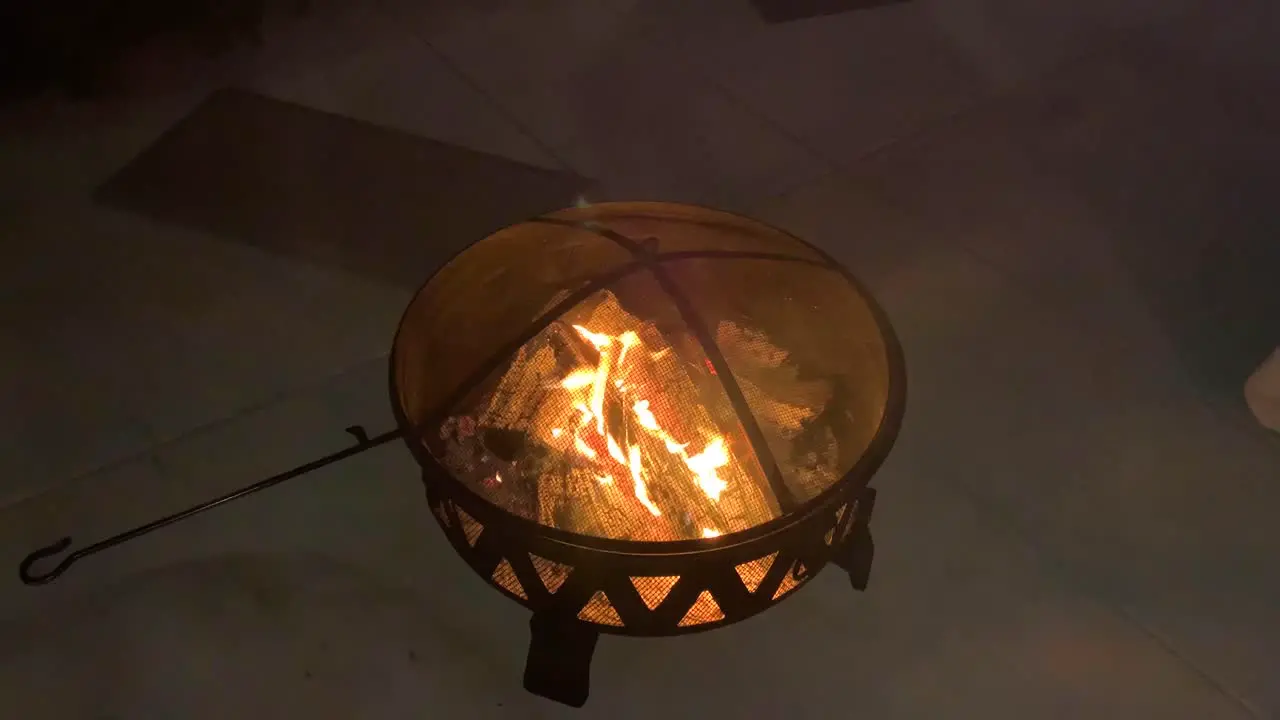 Footage of fire in a fire pit outside in a backyard in California