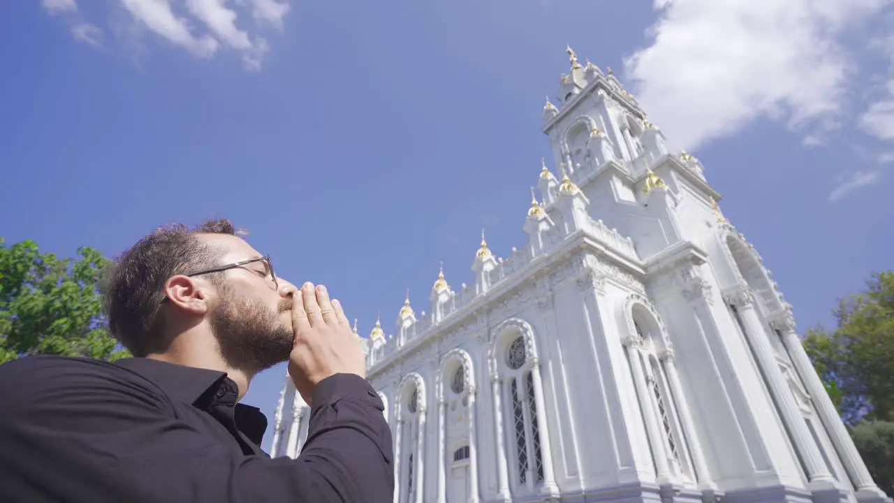 The person who looks at the church and prays