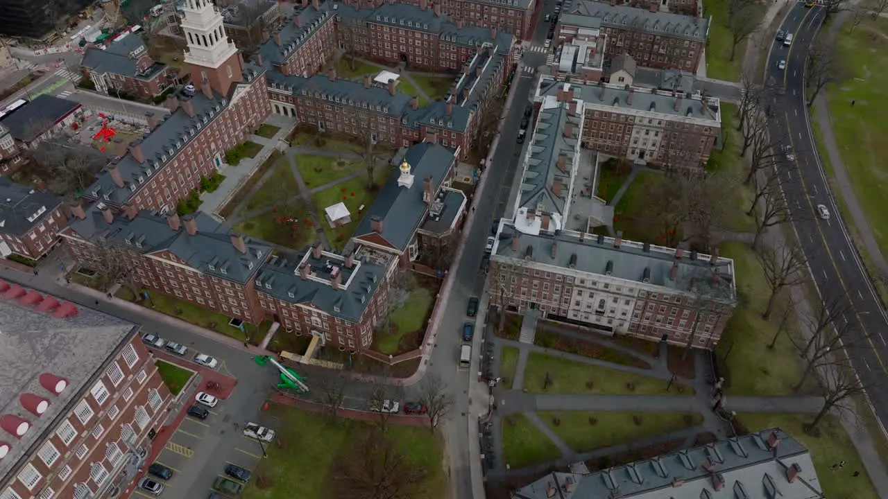 Aerial ascending footage of complex of historic red brick buildings in Harvard University campus Boston USA